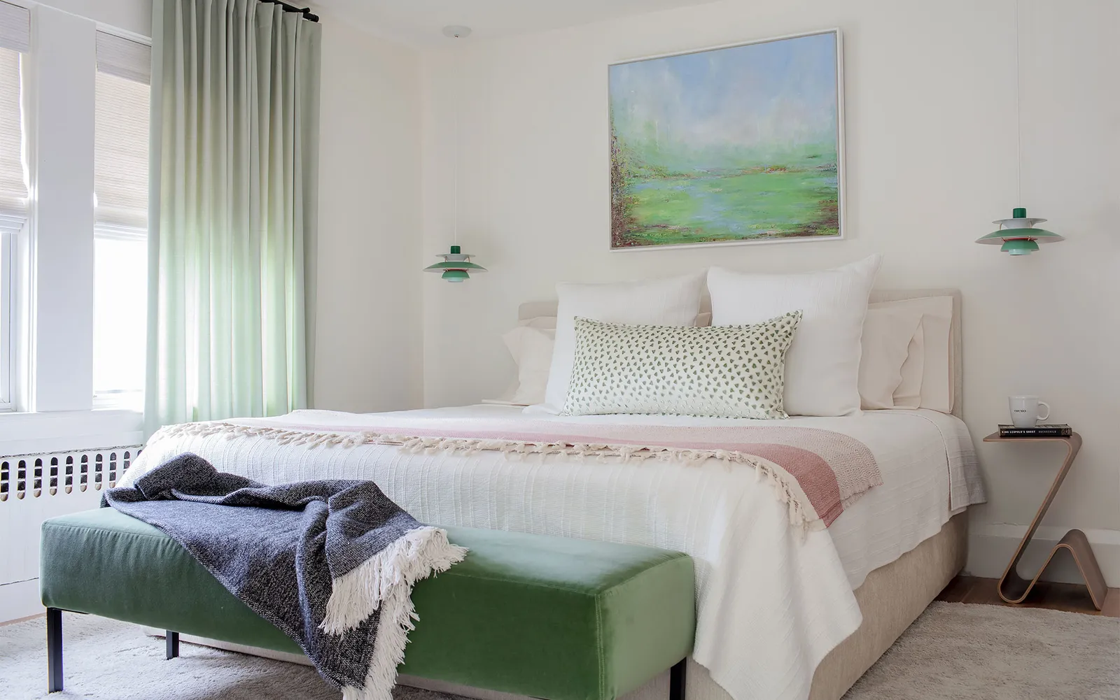 A bedroom with a large bed and a painting on the wall