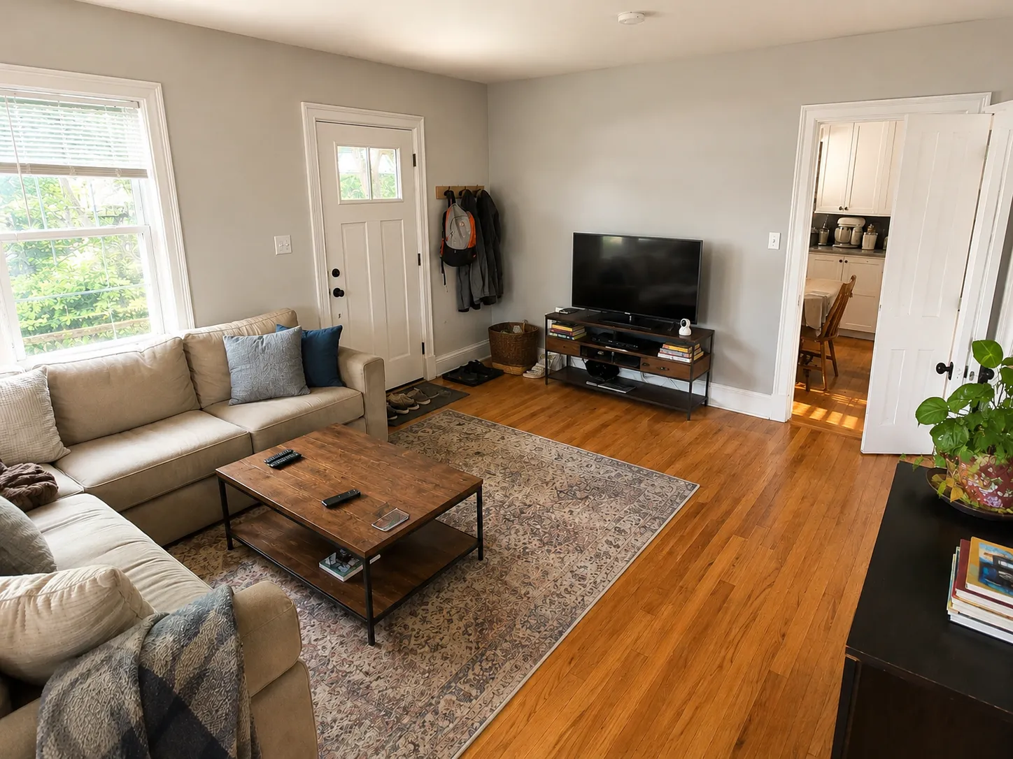 Freshly painted living room with warm hardwood floors and crisp neutral trim in a Sterling MA home