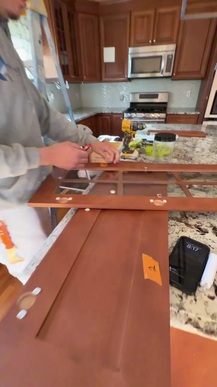 Pedretti's Cabinet Co. team member spraying a cabinet door