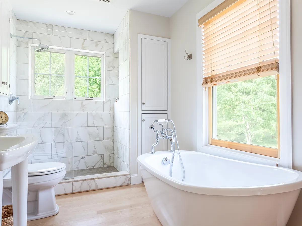 master bath with claw foot tub and wood floors