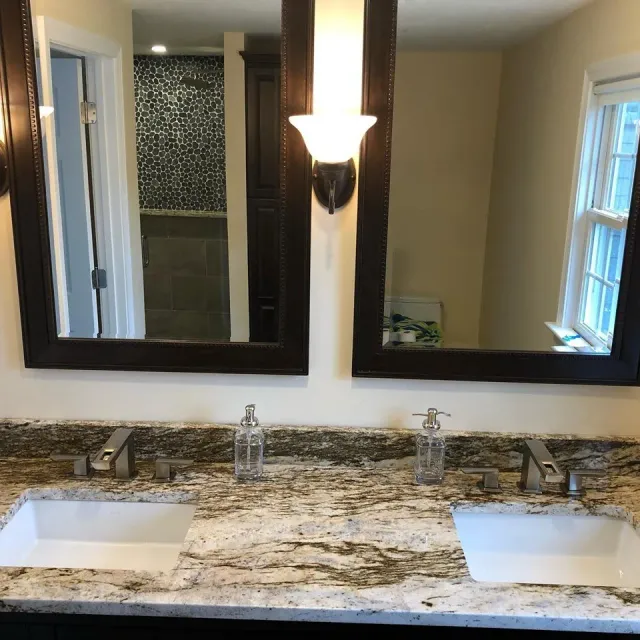 A bathroom with two sinks and two mirrors