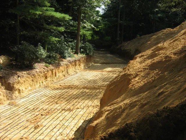 Geothermal horizontal loop run through wooded excavation
