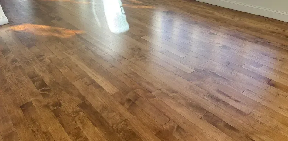 Polished wooden floor with bright light reflections