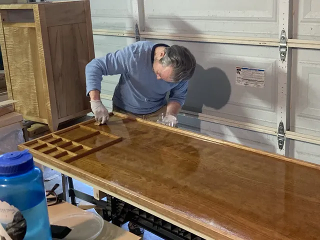 Austin applying finish to Lego table top