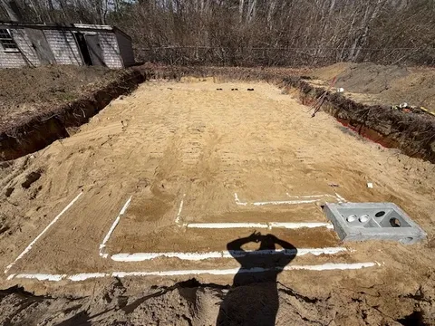 Large excavated area with plumbing.