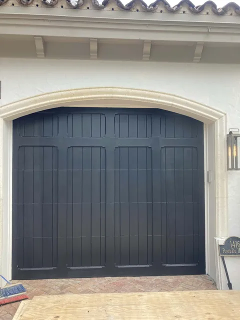Garage door refinished in a rich charcoal black.