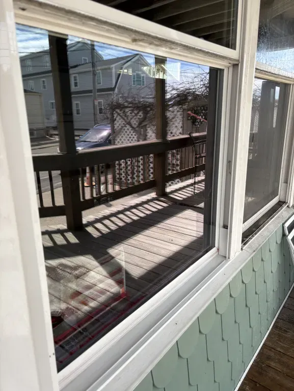 Crystal clear porch window after Mass Shine professional cleaning in Hull MA