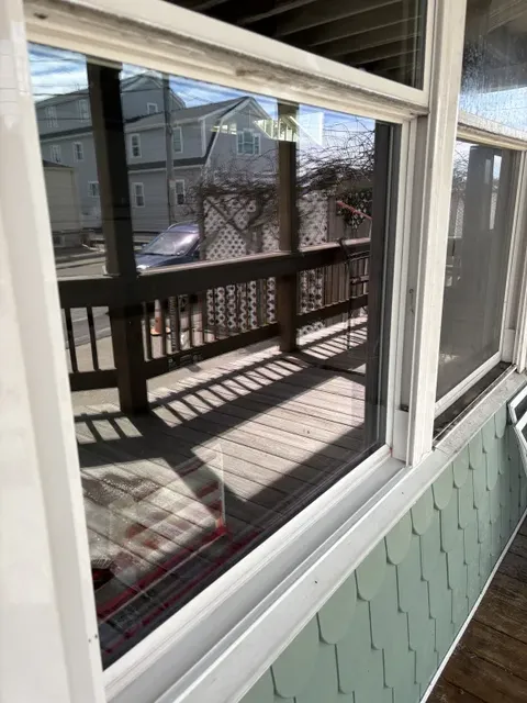 Crystal clear porch window after Mass Shine professional cleaning in Hull MA