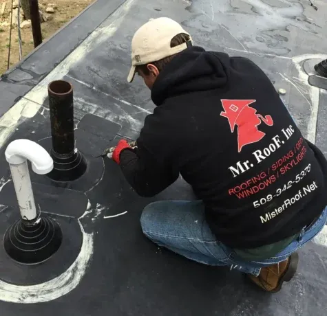 Detailed pipe sealing and leak repair on a flat roof in Norton for lasting roof protection.