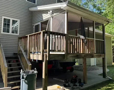 Wooden deck with screened porch  before renpovation and stairs leading to the backyard view.