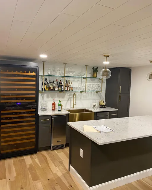 Finished kitchen and bathroom remodel with brass fixtures and dark cabinetry by Top Tier Plumbing & Heating LLC