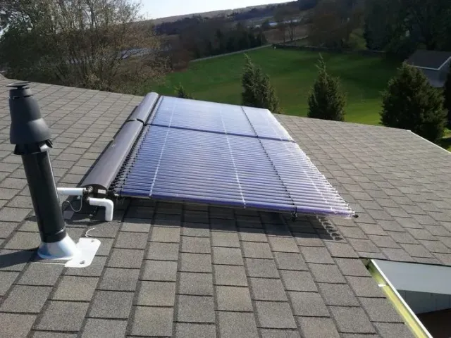 A solar panel is on the roof of a house