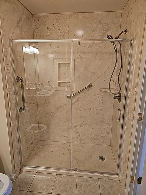 Frameless glass shower enclosure bathroom remodel