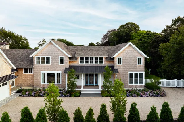 Our plant palette was intentionally curated to evoke the quintessential essence of Cape Cod, featuring ornamental grasses, an array of hydrangeas, and evergreen varieties. The arrangement of these plantings is both monolithic and bold, emphasizing t