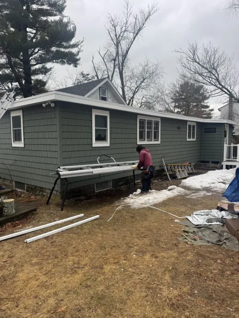 Siding installation in progress on a home in Lowell, MA
