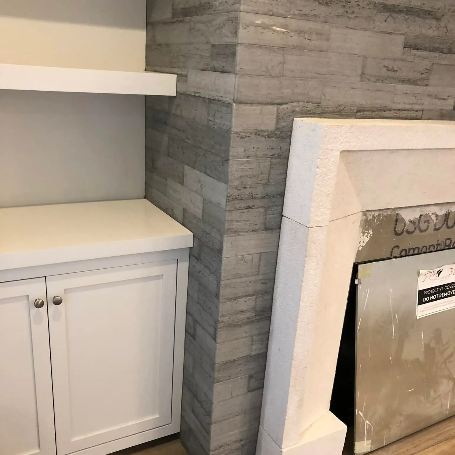 Stone tile feature wall with cabinetry