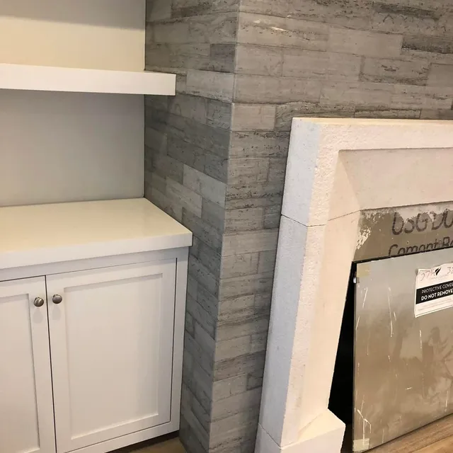 Stone tile feature wall with cabinetry
