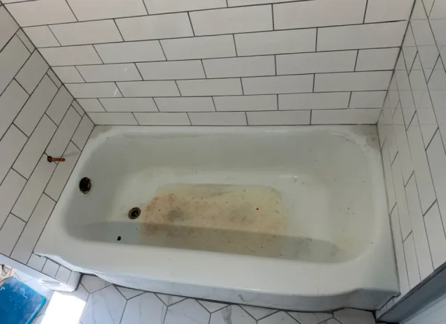 Stained, worn bathtub before reglazing in Rhode Island bathroom