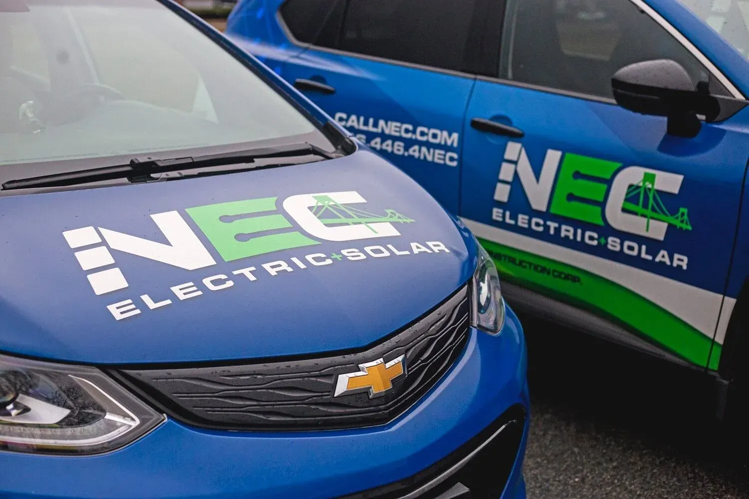 NEC Electric + Solar branded vehicles, close up