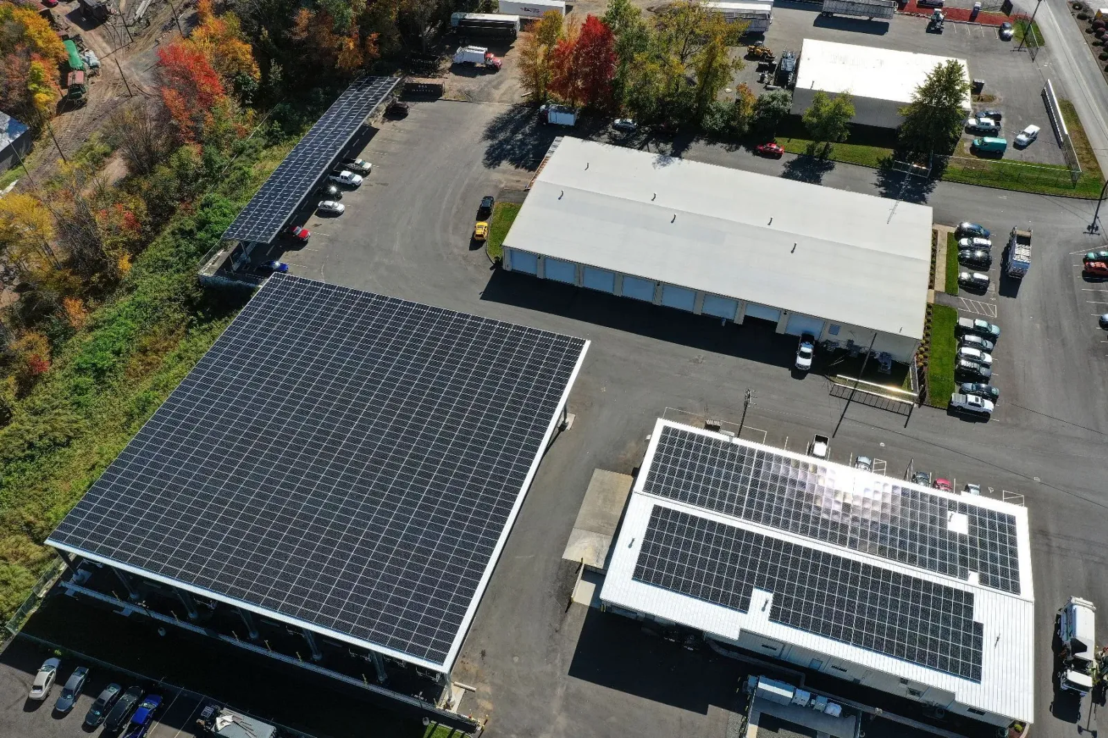 An aerial view of a building with solar panels on the roof.