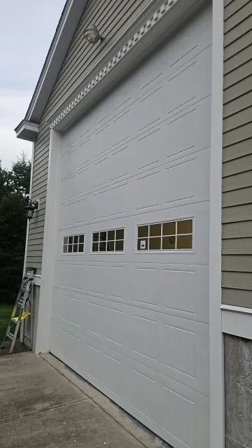 White paneled garage door with window inserts