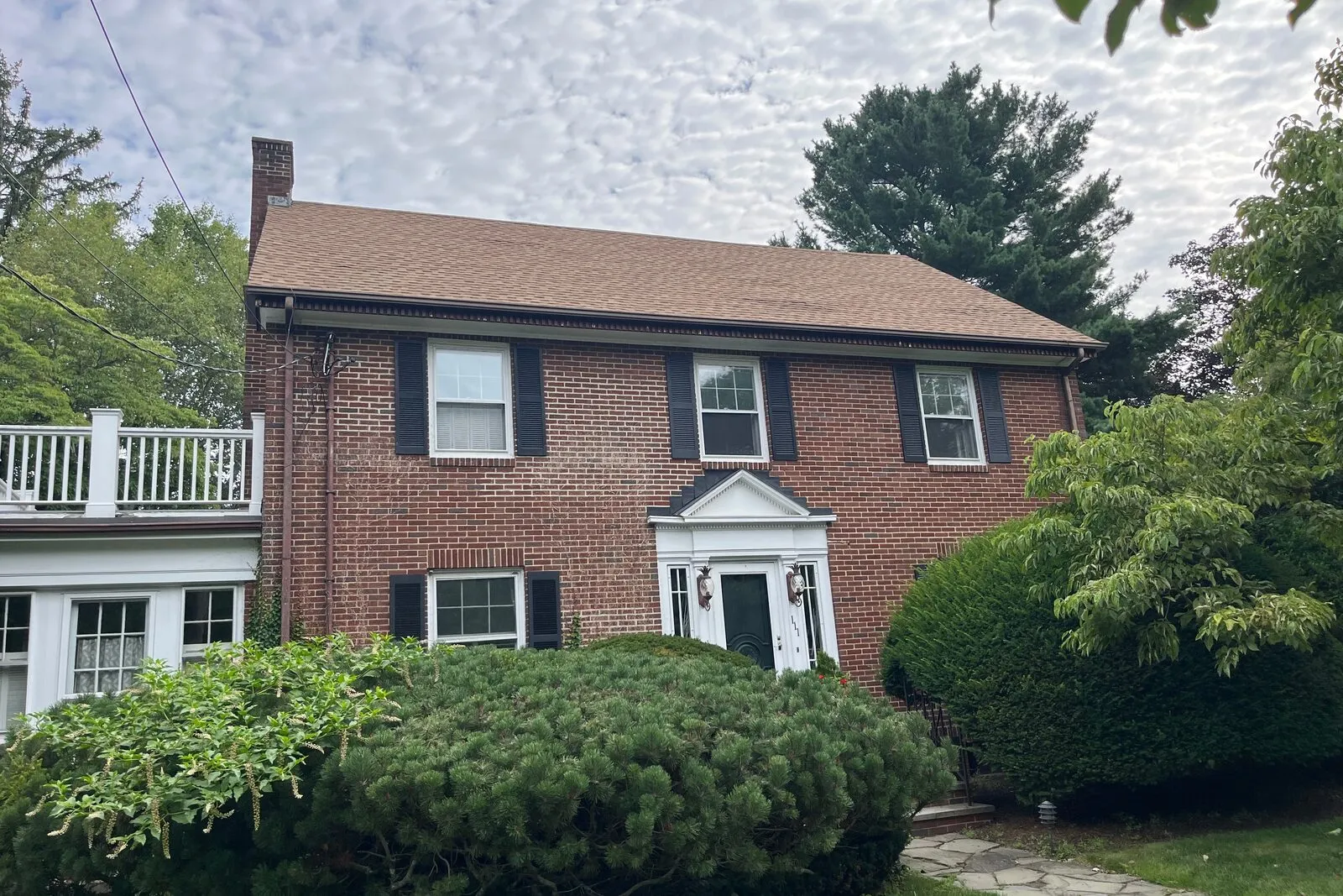 Architectural asphalt replacement on a Needham home with full ventilation and flashing rebuild.