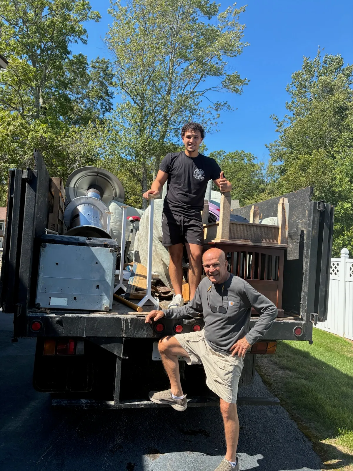 EasyScrap Team Member In Front Of Black Junk Truck