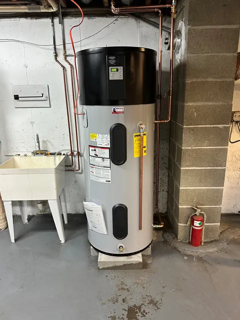 High-efficiency hybrid heat pump water heater — dramatically lower electric bills than a standard electric tank, installed on a level pad with proper condensate drainage.