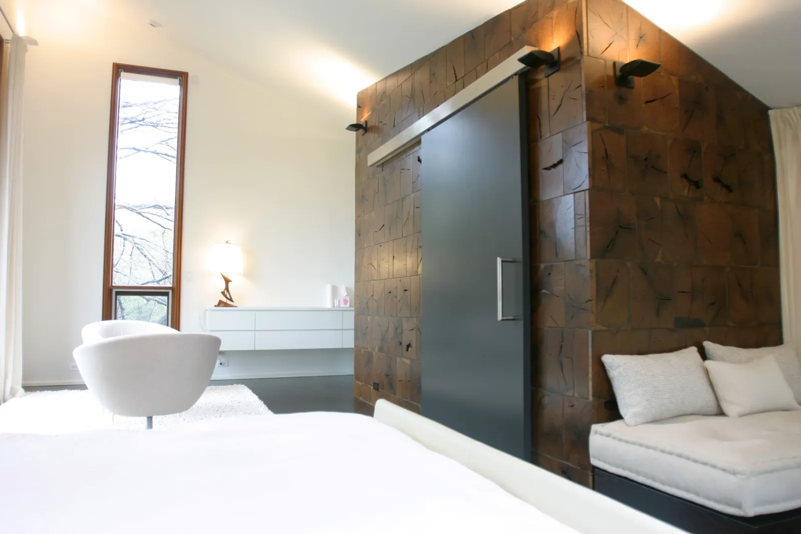 Master bedroom with walnut feature wall and sliding barn door