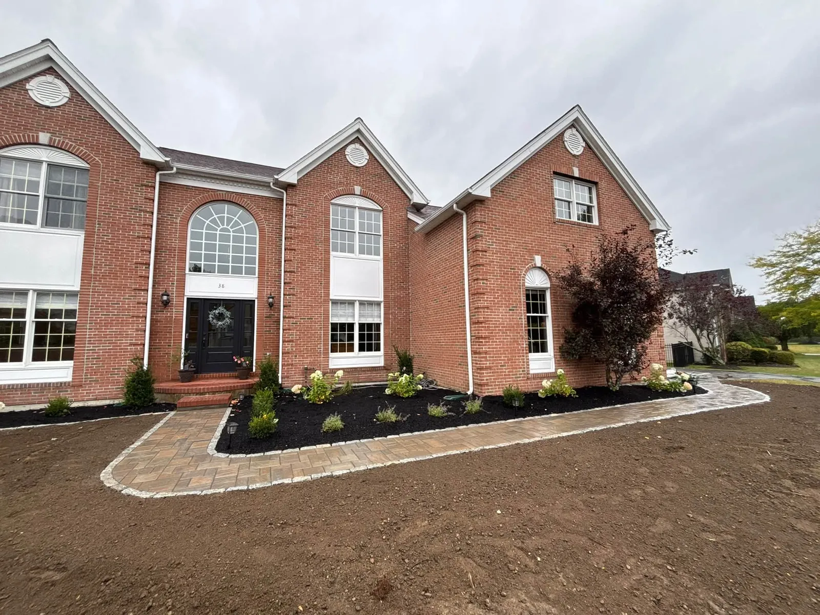Completed paver walkway with cobblestone borders and shrub plantings — Shrewsbury, MA