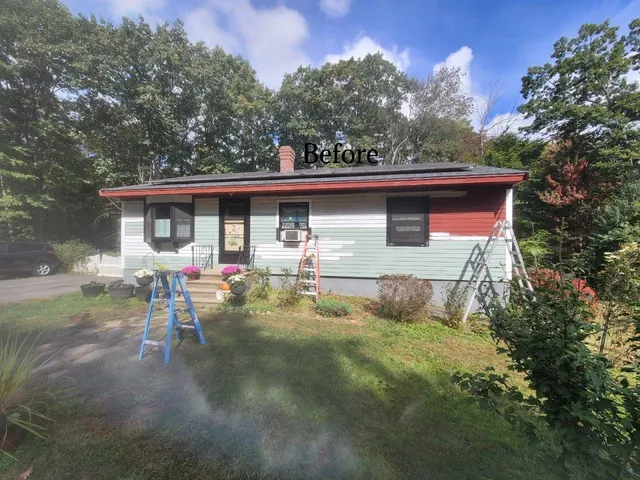 A ranch house with mismatched exterior colors before being restored by Impeccable Painting, featuring uneven paint and worn-out finishes.