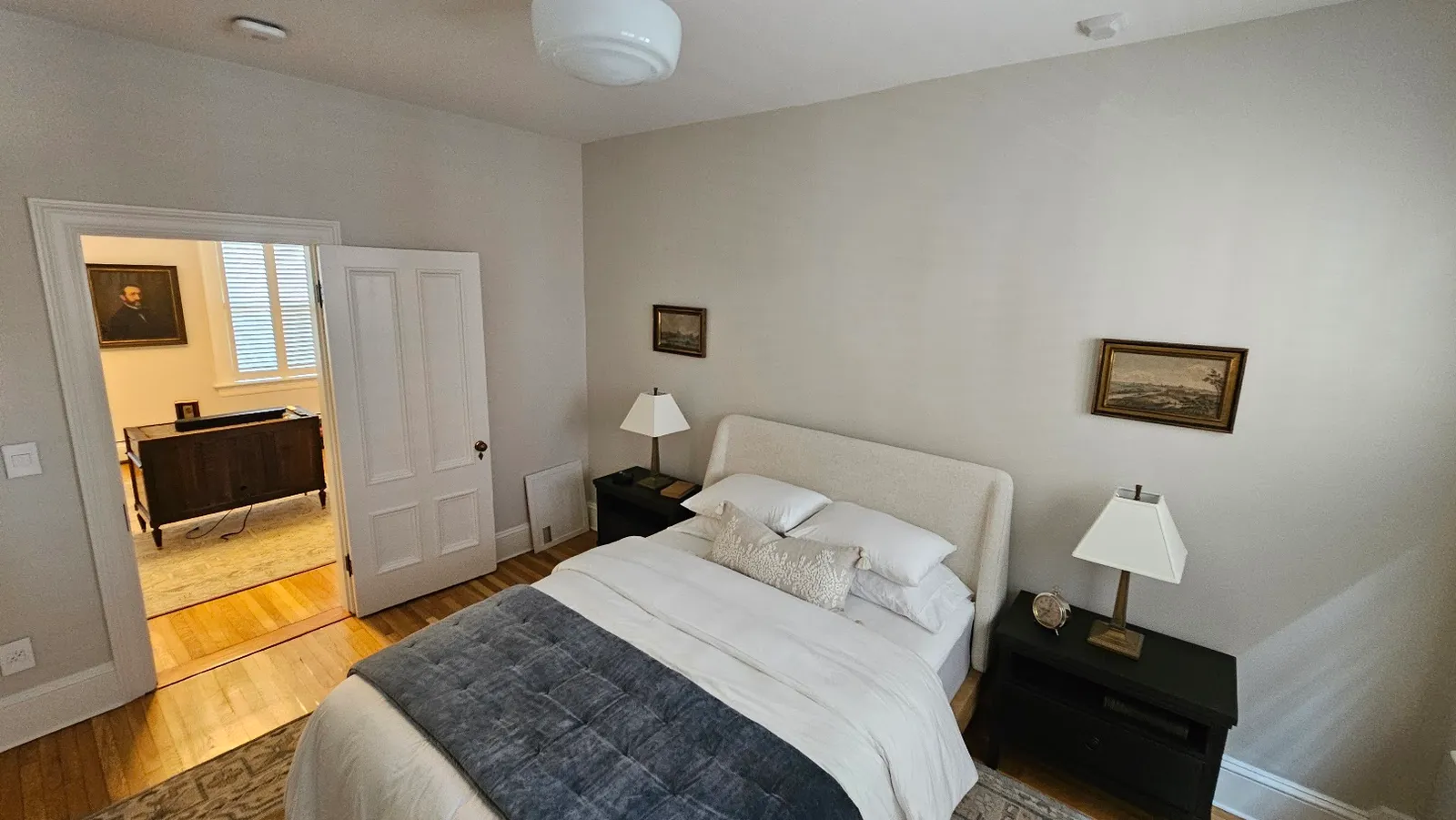 Restored bedroom in a historic Providence condo with refinished hardwood and new trim by Toensing Construction