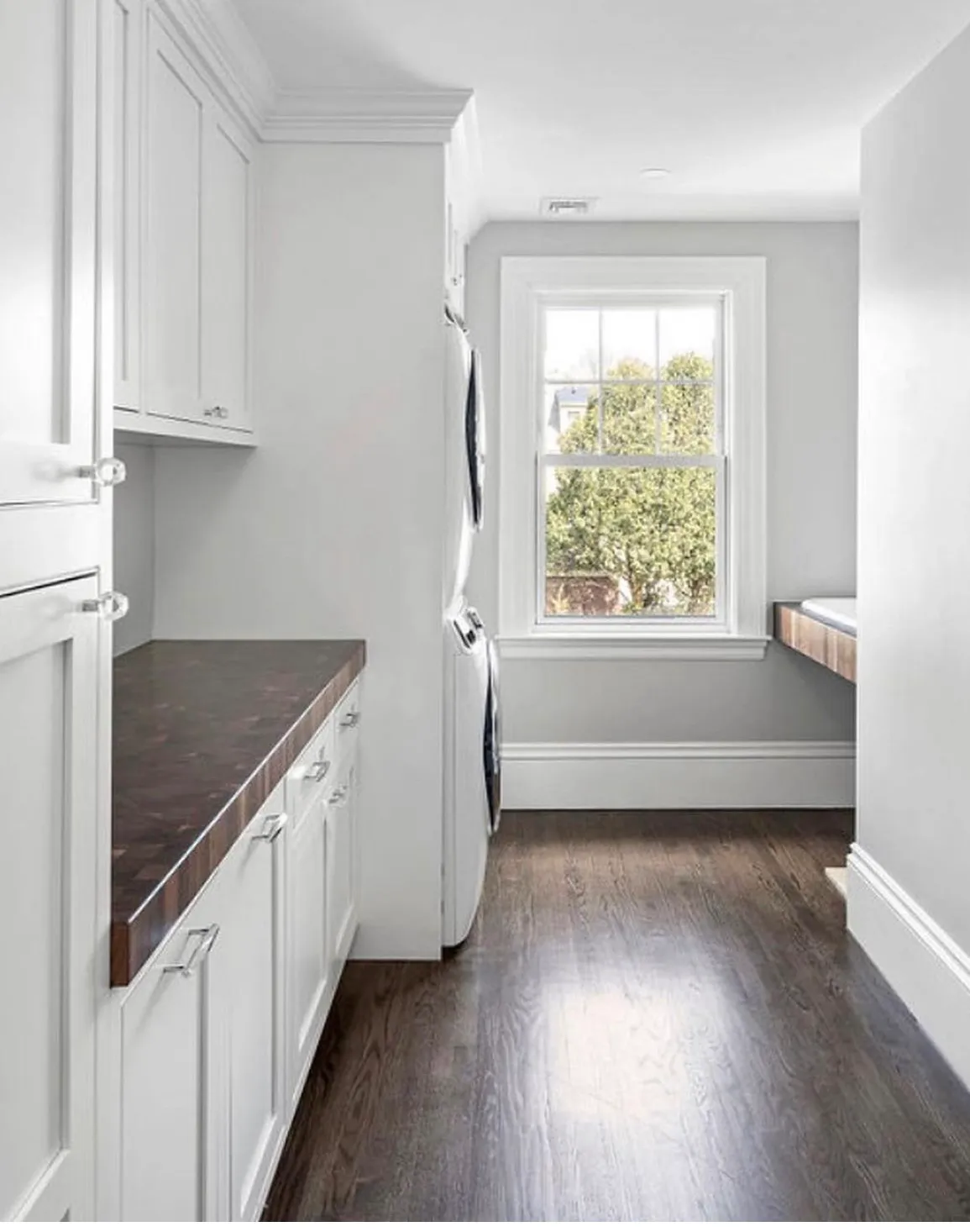 Custom laundry/mudroom cabinetry with butcher-block counter