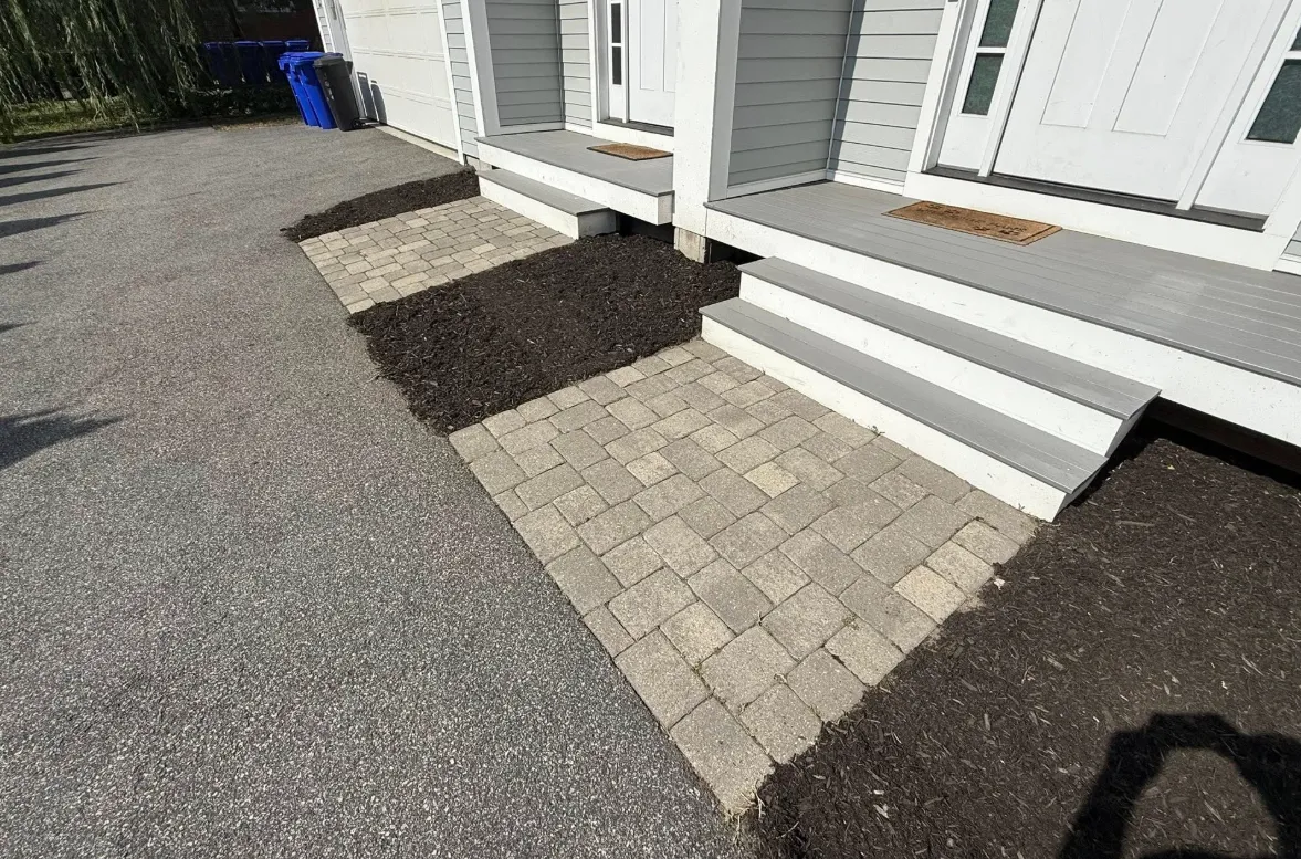 Front yard cleanup with paver landing and fresh mulch beds in Boston, MA