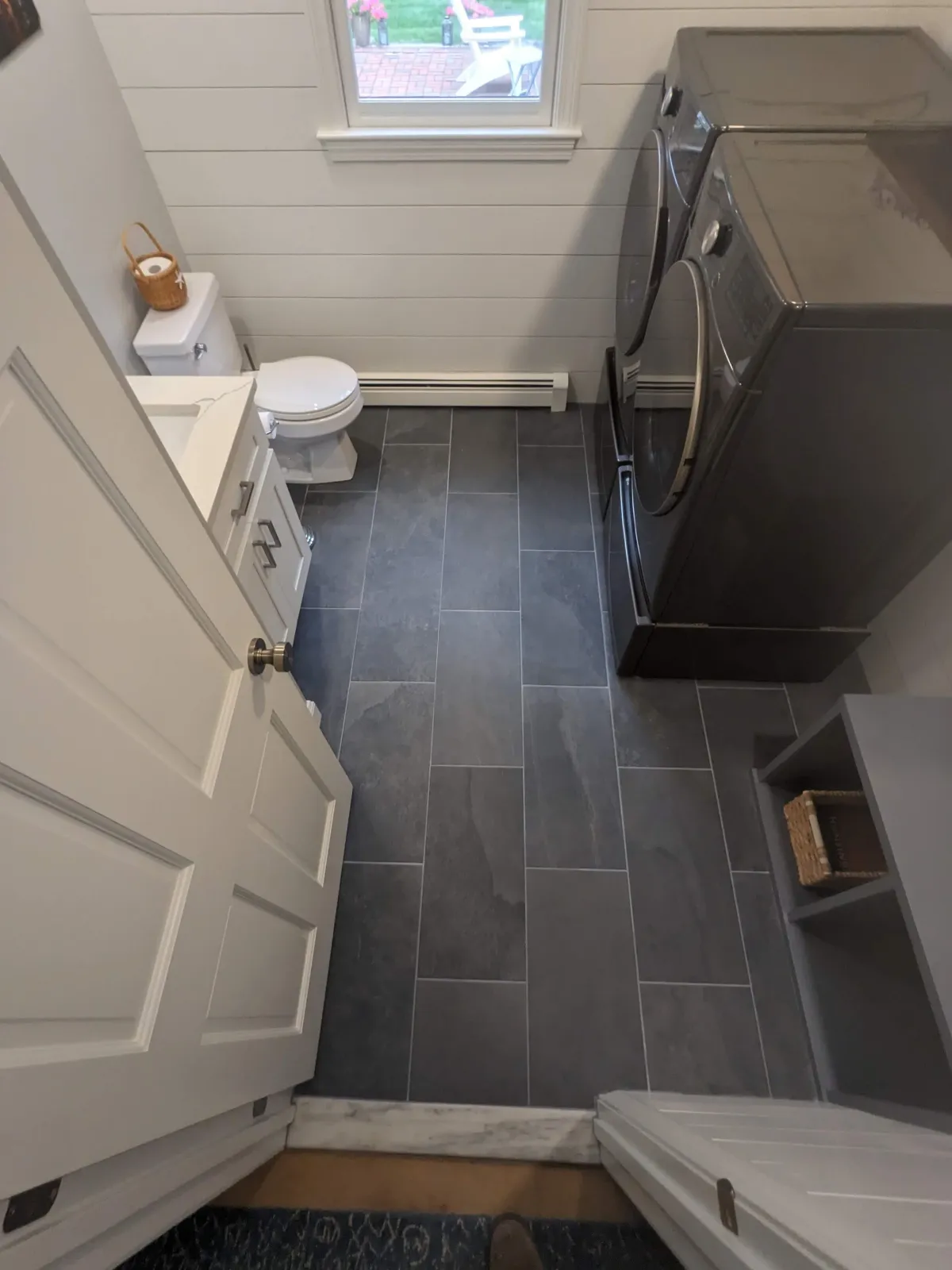 Bathroom remodel in Lakeville with new tile floor, open floor plan, shiplap walls, and custom carpentry.