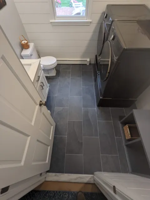 Bathroom remodel in Lakeville with new tile floor, open floor plan, shiplap walls, and custom carpentry.