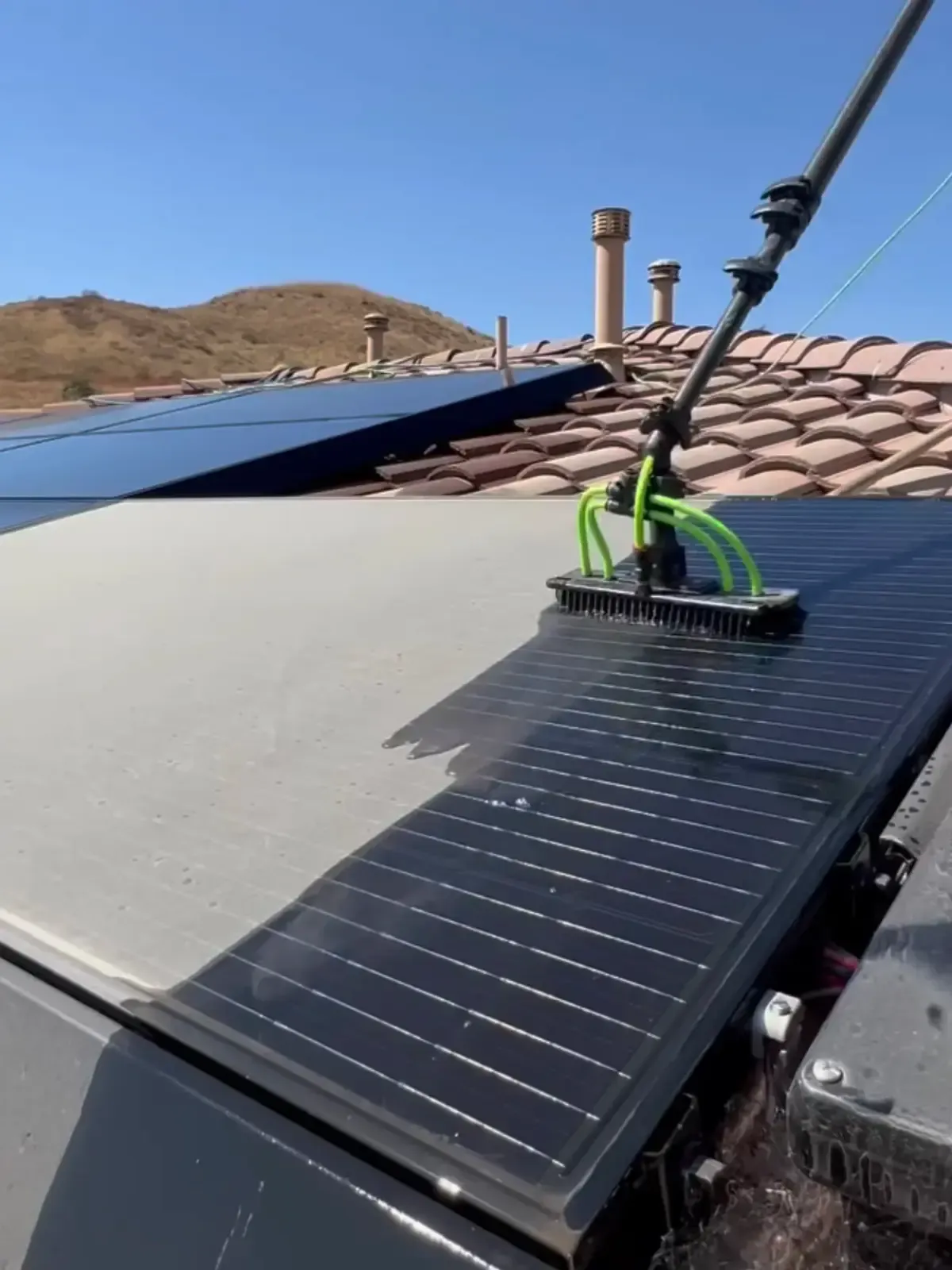 Solar panels on roof being cleaned