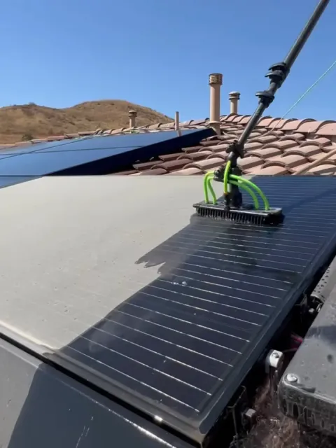 Solar panels on roof being cleaned