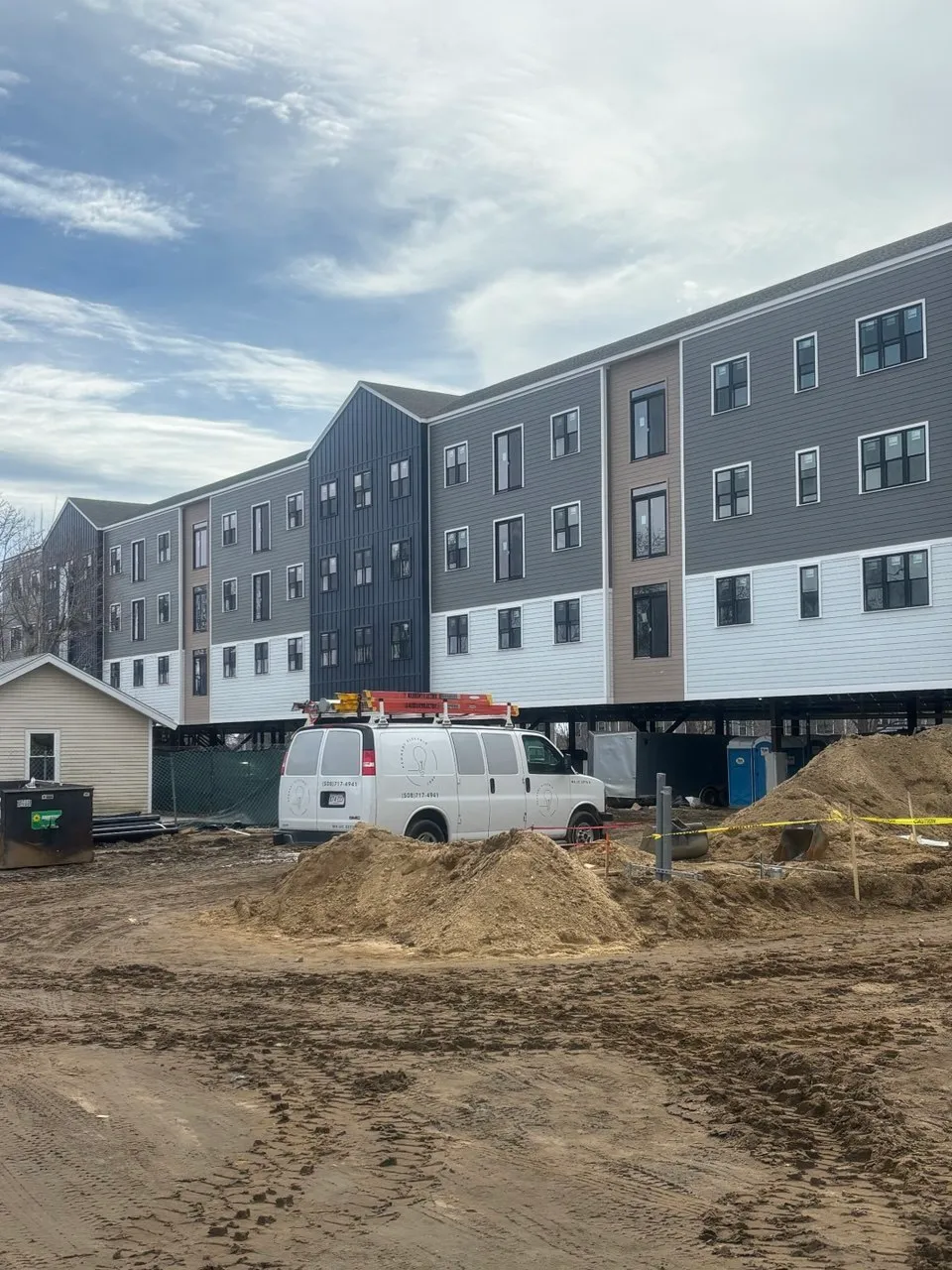 KEC van on-site at Hyannis Lofts — building under construction