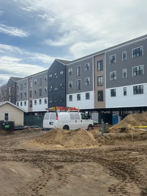 KEC van on-site at Hyannis Lofts — building under construction