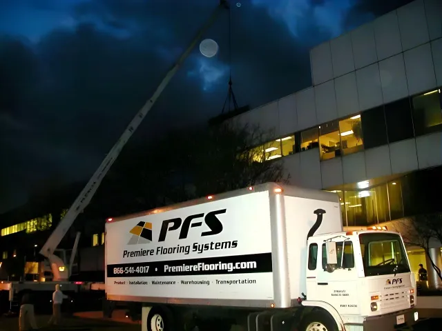 PFS truck beside illuminated office building