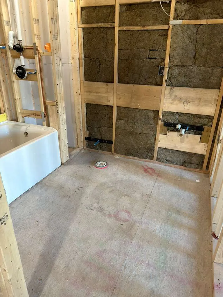 Complete bathroom plumbing installation including sink, shower, and toilet