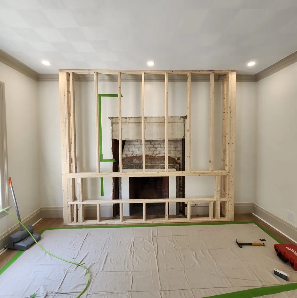 New stud framing built around the chimney wall