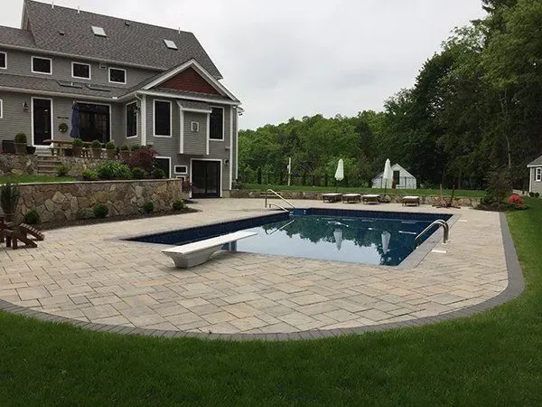 A large house with a large swimming pool in front of it