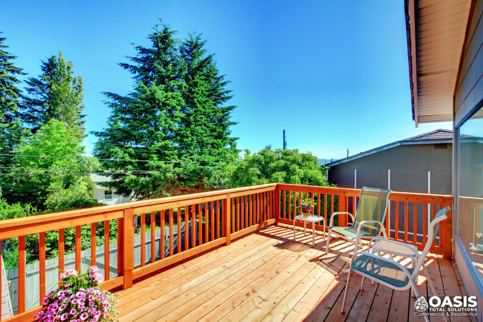 Completed wood deck with lounge chairs and privacy railing