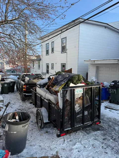 Empty trailer with ramp down and hand truck staged, ready to load
