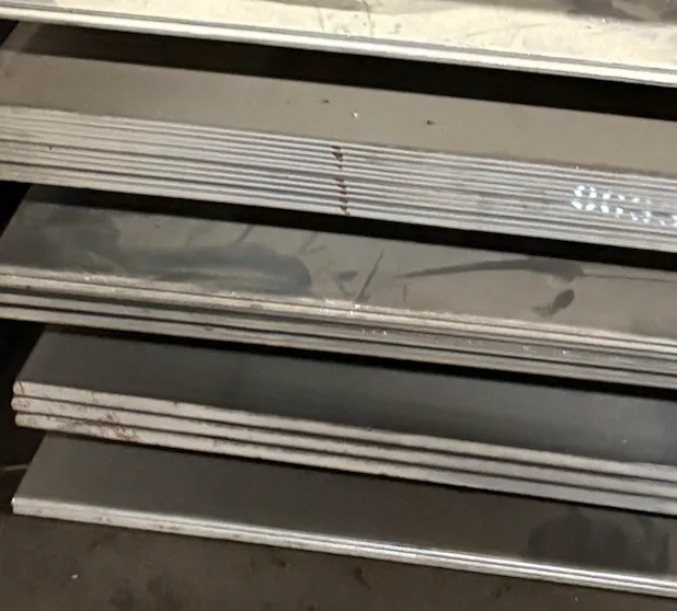 Metal shelves or drawers stacked on top of each other with some rust and dirt marks.