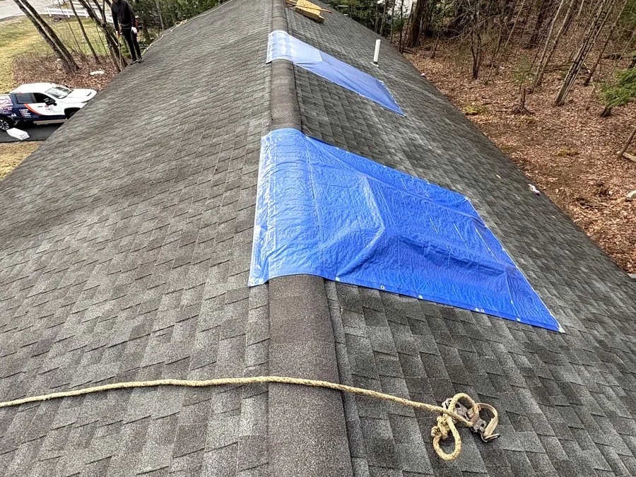 Emergency tarp installed on a leaking roof