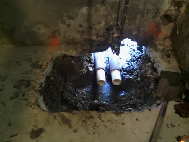 New drain lines set into a broken-out basement slab