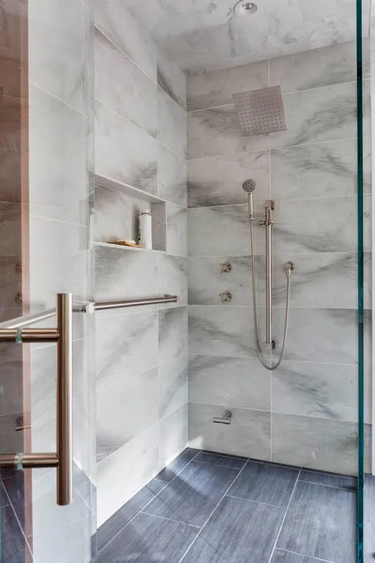Modern glass-enclosed shower with tile interior